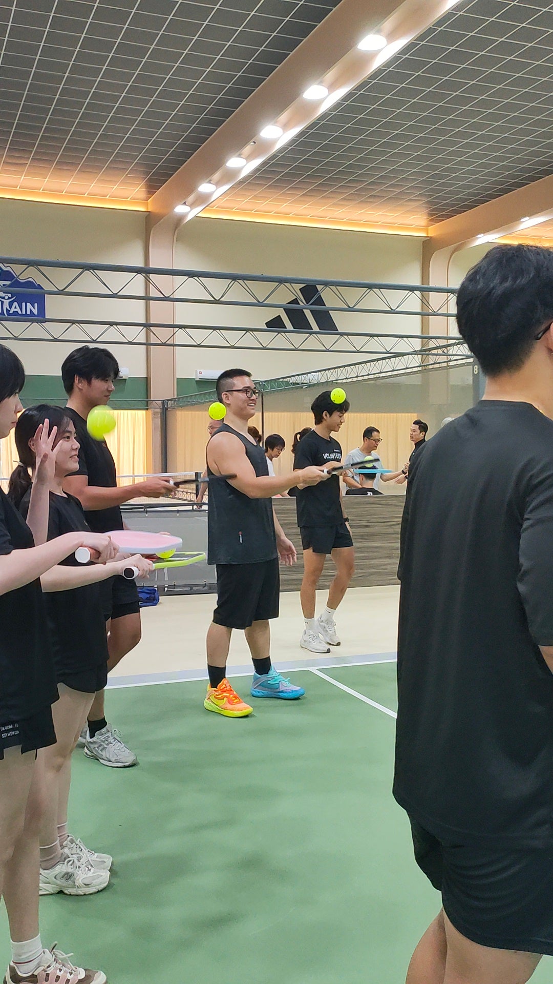 Player learning pickleball fundamentals during a first Paddle Pickers session